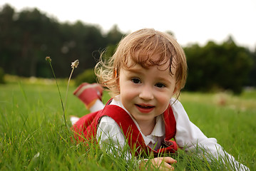 Image showing Close-up little girl on the green grass outdoor