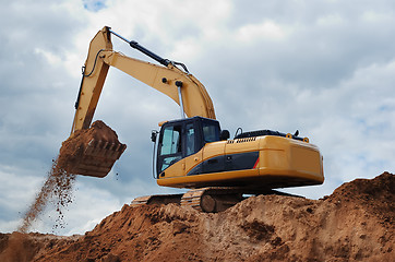 Image showing Excavator with earth in the bucket