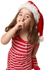 Image showing Little girl in santa hat gesturing peace and quiet