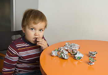 Image showing Boy eating chocolates