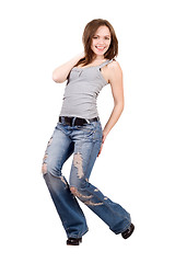 Image showing Smiling young woman in a blue jeans. Isolated