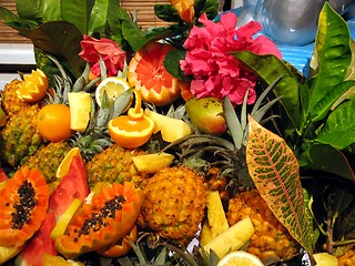 Image showing Tropical cocktail fruits, decoration with flowers and leaves