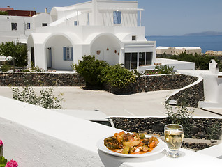 Image showing greek island specialty food grilled vegetables with white wine v