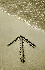 Image showing Arrow sign drawn in sand