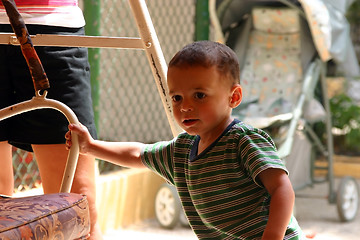 Image showing Little Boy Pushing the Swing