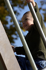 Image showing Kid Climbing Up the Slider