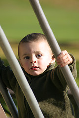 Image showing Kid Climbing Up the Slider with Hand in Focus