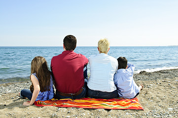 Image showing Family sitting at beach