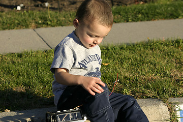 Image showing Little Boy Looking Down at the Antenna