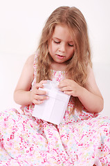 Image showing Little girl opening present