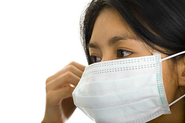 Image showing woman putting on a face mask