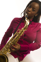 Image showing young hispanic black woman playing tenor saxophone