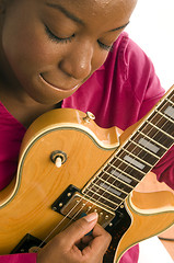 Image showing young hispanic black woman playing electric guitar