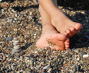 Image showing Rocks stack and boy feet