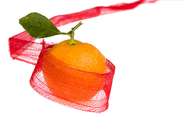 Image showing christmas sweet in red bow. orange fruit
