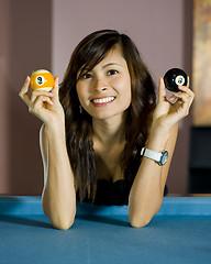 Image showing girl showing an eight and nine ball