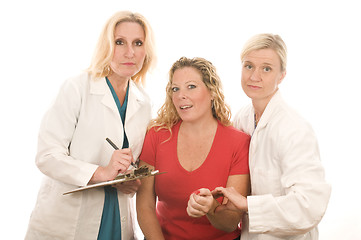 Image showing two doctors nurses in medical scrubs clothes with patient