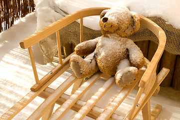 Image showing Teddy Bear toy and slide with snow covering