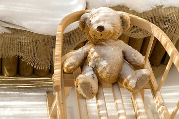 Image showing Teddy Bear toy and slide with snow covering