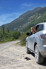 Image showing Feet and Flip Flops Outside The Car