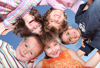 Image showing Five Friends Outdoors Looking Down Smiling