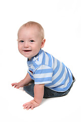 Image showing Smiling Bright Baby Boy Sitting and Looking Back