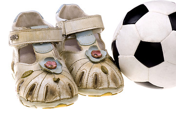 Image showing Baby football shoes and ball on white background