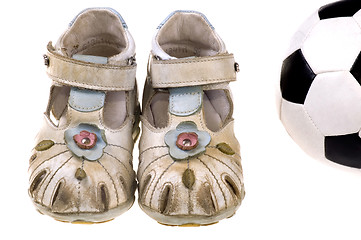 Image showing Baby football shoes and ball on white background