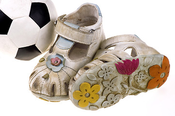 Image showing Baby football shoes and ball on white background
