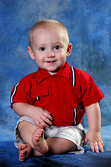 Image showing Portrait of a Young Boy Against Blue Background