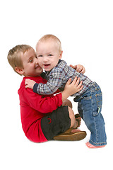 Image showing 2 Brothers Hugging Eachother on White Background