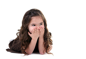 Image showing Adorable Little Girl Covering Her Mouth Laughing