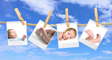 Image showing Baby Photos Hanging Against a Blue Cloudy Sky