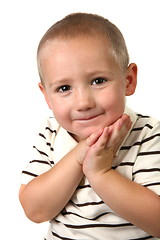 Image showing Young Child With Hands Against His Face