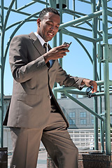 Image showing Business Man Checking His Mobile Phone Smiling