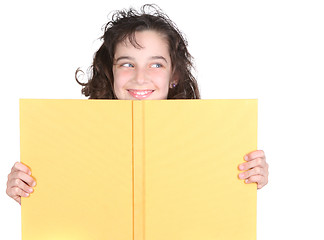 Image showing Little School Girl Looking Over Her Book