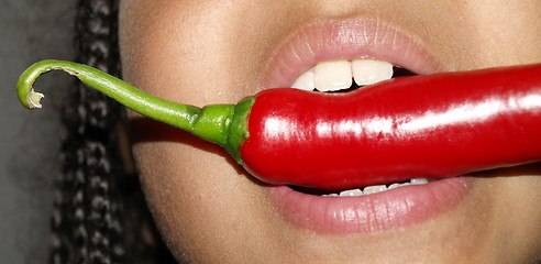 Image showing girl tasting chilli