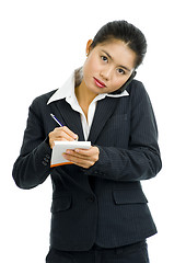 Image showing business woman on the phone taking notes