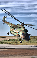 Image showing Military helicopter over land