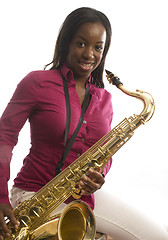 Image showing young african american girl playing saxophone music