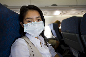 Image showing woman with protective mask in a plane