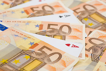 Image showing aces between euro bills