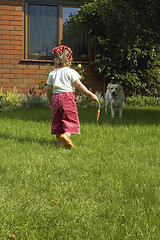 Image showing little girl with best friend and carrot