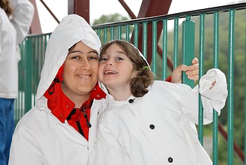 Image showing Mother and daughter in white hooded cloaks 