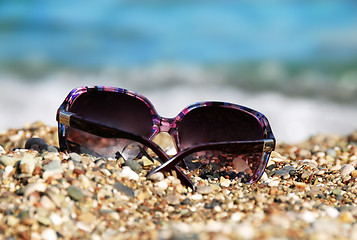 Image showing Sunglasses in pebble