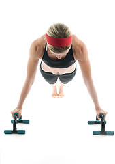 Image showing   woman exercising doing push up with fitness push up bar front 