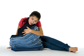 Image showing young woman with her jeans collection