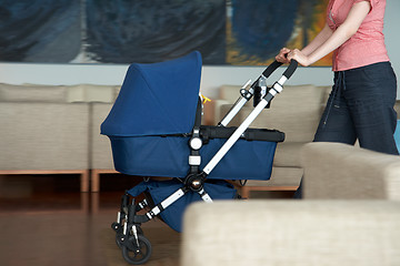 Image showing woman indoor with a stroller