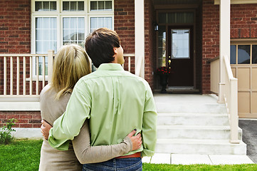 Image showing Happy couple in front of home