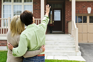 Image showing Happy couple in front of home